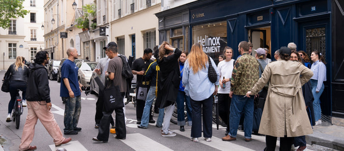 Crowd of people standing on a city street outside the Helinox x Fragment pop-up store event