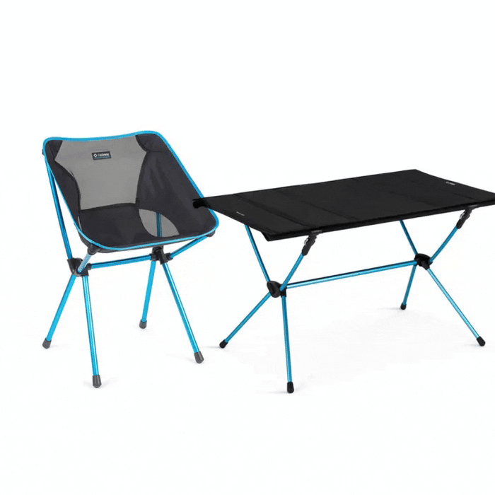 A single camping chair next to camping table.