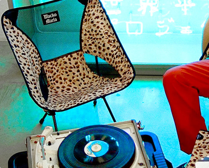 Helinox x Wacko Maria leopard print camp chair next to a vinyl record player